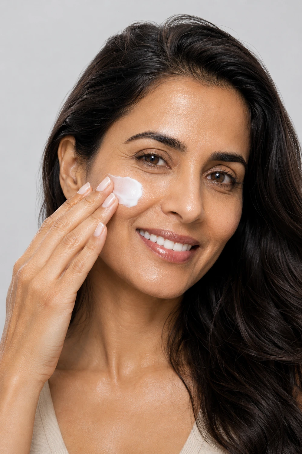 Adult model applying moisturiser